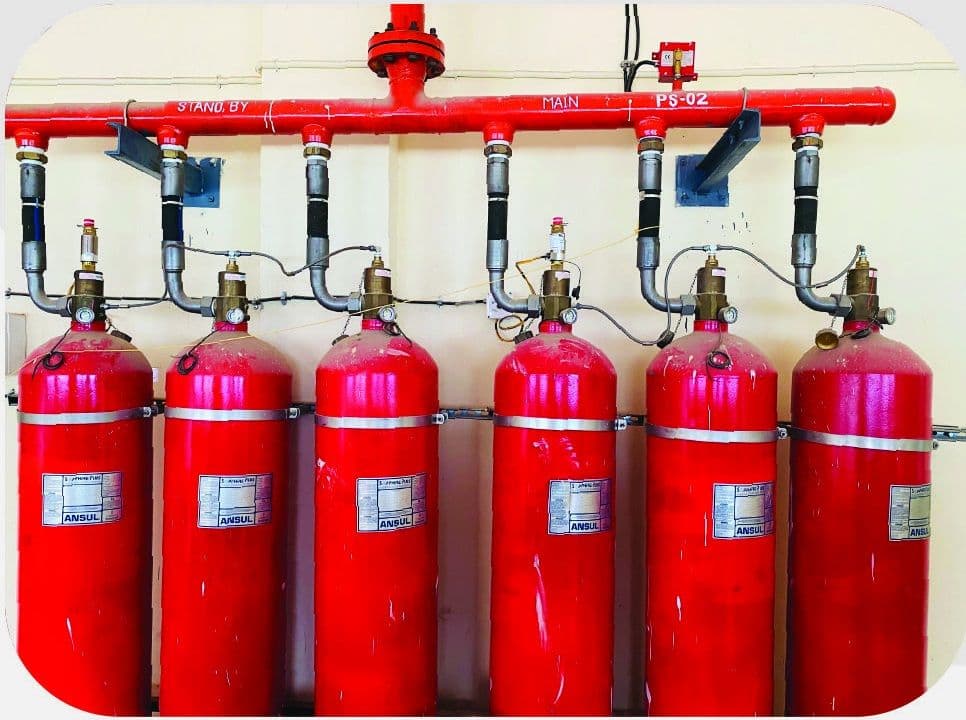 Clean agent cylinders and discharge manifold installed in a plant room
