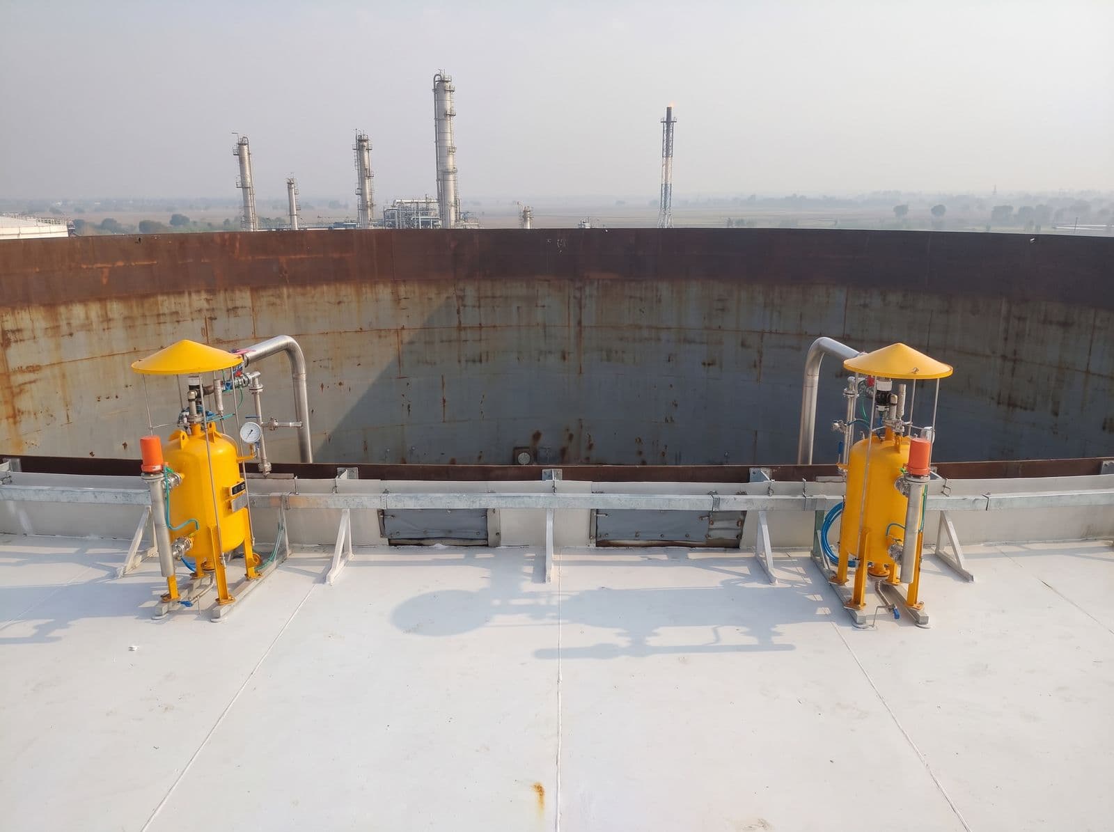 Rim seal fire protection units around the floating roof of a storage tank at an inland refinery